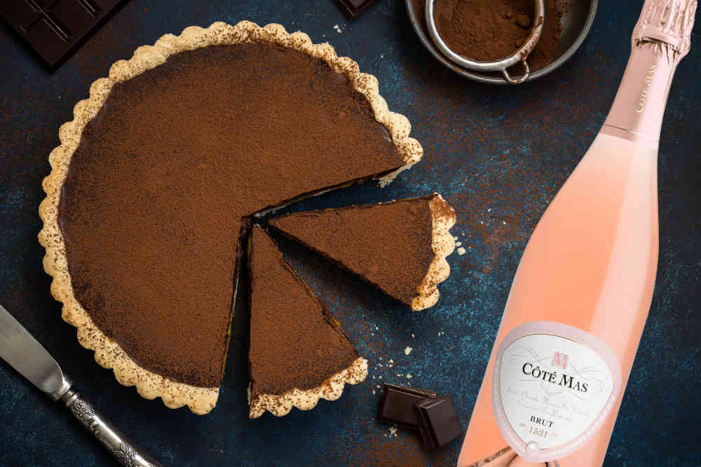 chocolate and caramel tart on dark blue background